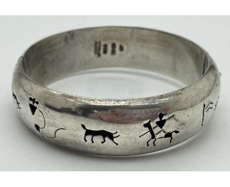 A 925 Mexican silver hinged bangle with pierced detail, approx. 1.8cm band width. Safety chain broken. Fully hallmarked insid