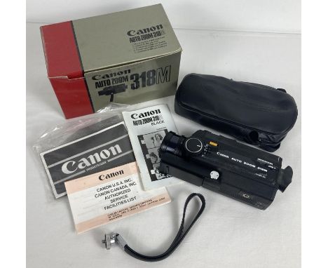 A boxed vintage Canon Auto Zoom 318M cine camera complete with instructions. Original paperwork, receipt, wrist band attachme