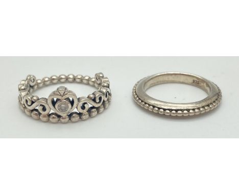 A boxed Pandora Tiara ring together with a band ring (possibly Pandora). Tiara ring set with a clear coloured stone, marked S