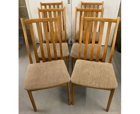 A set of 6 mid century light wood slat backed dining chairs. With curved seats covered in beige/brown upholstery. 