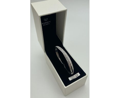 A boxed modern design silver tone bangle set with Swarovski crystals, with crossover clip clasp. 