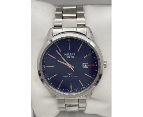 A mens boxed 431580 Solar wristwatch by Pulsar with blue face and stainless steel strap and case. Silver tone hour markers an