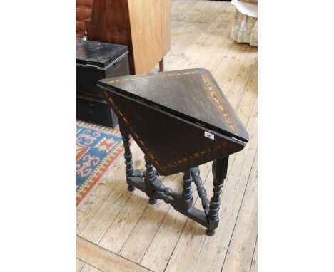 An early 19th Century oak gate leg corner table of Flemish design