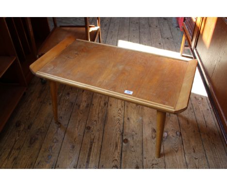 A vintage blonde teak coffee table