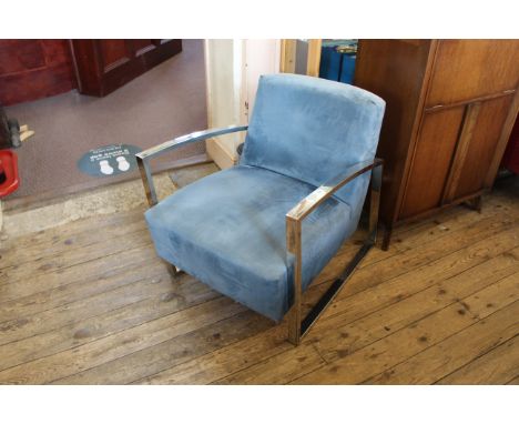 An angular vintage chrome and blue suedette upholstered armchair