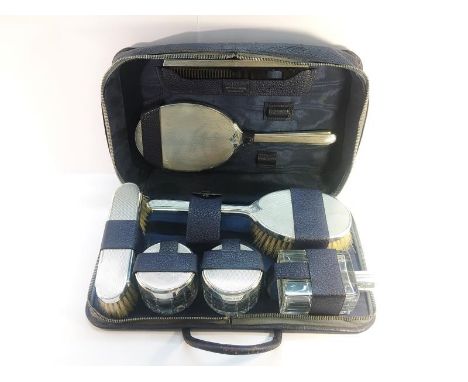 A Sterling Silver Mappin and Webb Cased Vanity Set, hallmarked London 1937. Consisting of 7 items including engine turned sil