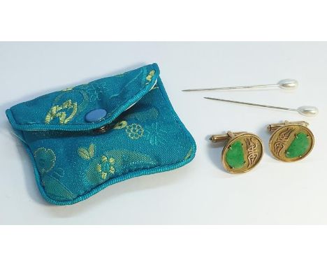 A pair of Chinese round plaque cufflinks, hallmark illegible, tests as gold, higher than 9ct. Set with carved jade panels. To