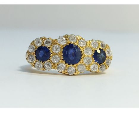 A Victorian Diamond and Sapphire three stone ring in 18ct yellow gold ornate shank. The three Ceylon sapphires have an ETCW o