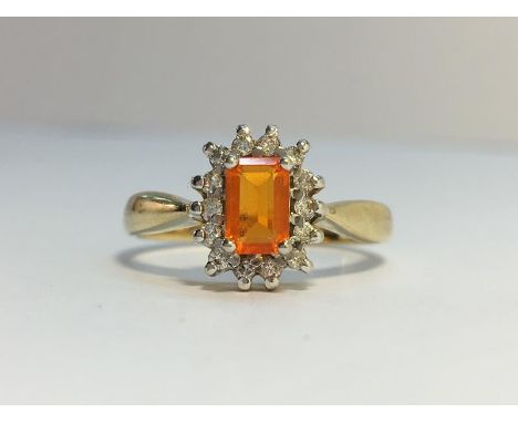 A Fire Opal and Diamond Cluster Ring set in 9ct yellow gold. The fire opal is estimated 0.5 cts, diamonds 0.15 cts stamped in