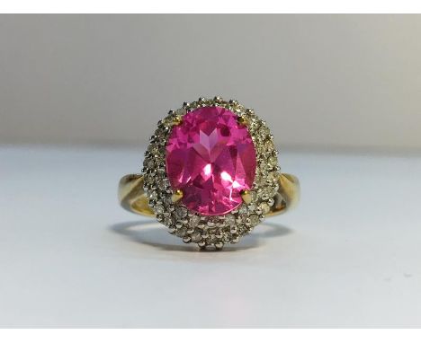 A Pink Sapphire and Diamond Cluster Ring in 9ct yellow gold. Diamonds ETCW 0.44 ct, sapphire ECW 3.2 ct. Ring size K and a ha
