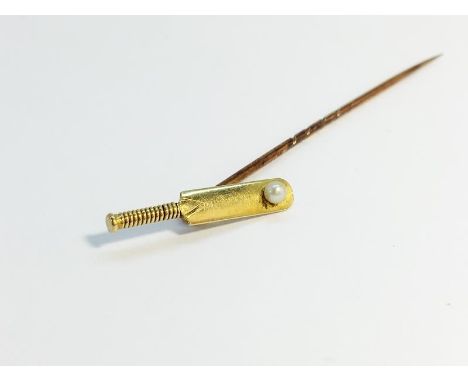 A cased Tie pin fashioned as a cricket bat with 18ct gold head, set with a seed pearl. Total weight of article 1.89 grams.