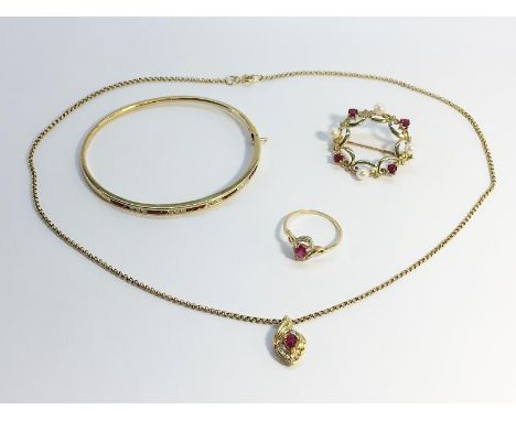A small lot of Ruby jewellery set in gold. To include a 14 carat gold channel set ruby and diamond bangle, inscribed inside '