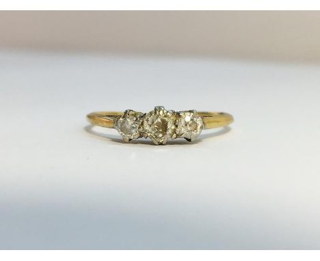 An Edwardian Diamond three stone Trilogy ring, set in 18 ct yellow gold with Platinum top. The ETCW of the three old cut diam