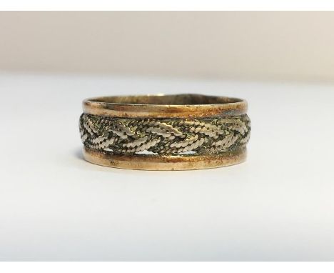 A Celtic Pattern Band Ring in 9ct white and yellow gold. Ring size P. Total weight 2.3 grams.