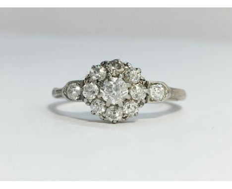 An Edwardian Diamond Cluster Ring with diamond set shoulders set in 18ct white gold with a platinum top. ETCW 0.60 cts. Ring 