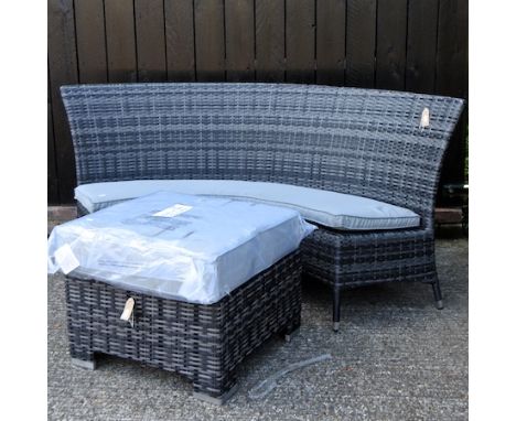 A curved rattan garden bench, with cushions, 175cm, together with a coffee table