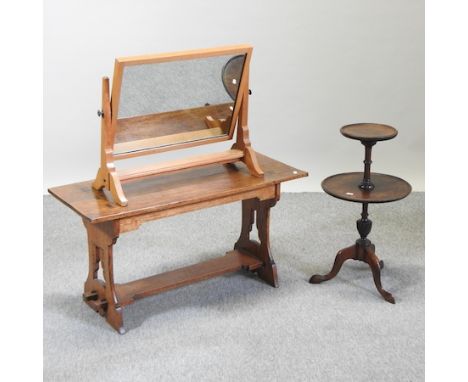 An early 20th century light oak swing frame toiletry mirror, stamped AM, together with an oak occasional table and a coffee t
