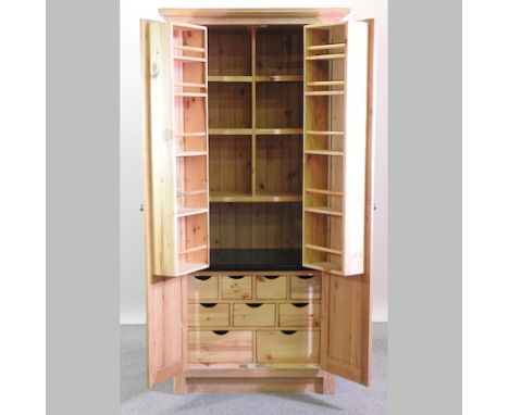 A light oak kitchen larder, with a granite and fitted interior, 100cm