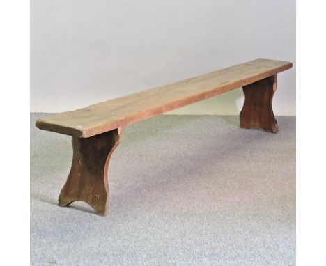 A rustic oak bench, on trestle supports, 255cm long