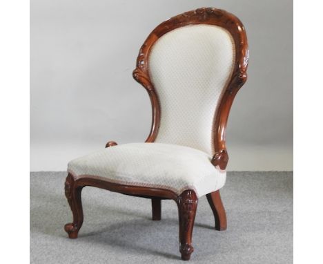 A Victorian style spoon back cream upholstered nursing chair