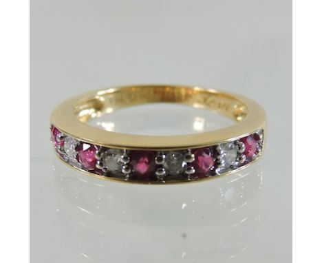 An 18 carat gold ruby and diamond eternity ring, boxed