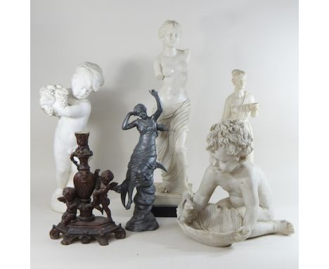 A classical plaster figure of a putti, 51cm high, together with various other similar figures and a resin candlestick
