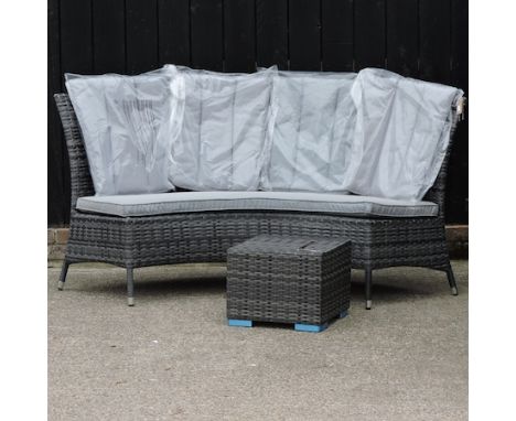 A curved rattan garden bench, with cushions, 175cm, together with a coffee table