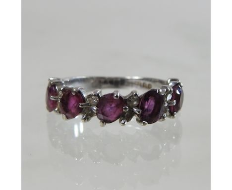 An 18 carat ruby and diamond half hoop eternity ring