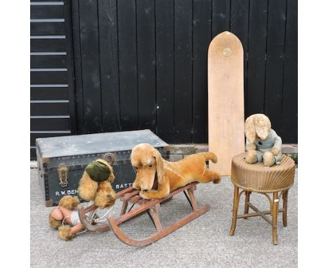 A vintage studded trunk, 90cm, together with a plywood surfboard, a wooden sledge and various stuffed toys