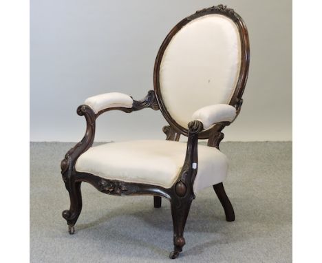 A Victorian cream upholstered spoon back armchair