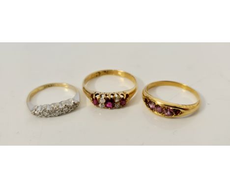 A five stone diamond ring, ring size C, a three stone ruby ring each one separated by diamonds stamped 18ct, ring size M, and