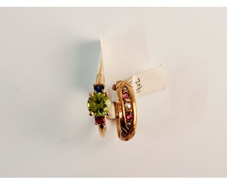 A hallmarked 9ct yellow gold ruby and seed pearl ring, ring size K, and a yellow metal three stone multi coloured ring, ring 