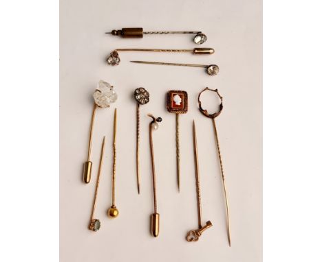 A collection of 11 various stick and tie pins