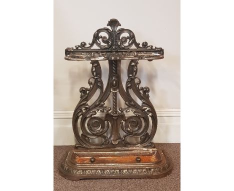 A Victorian cast iron stick stand with drip tray.