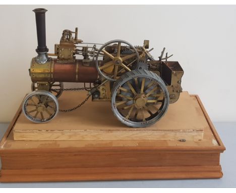 A copper and brass live steam traction engine in case.