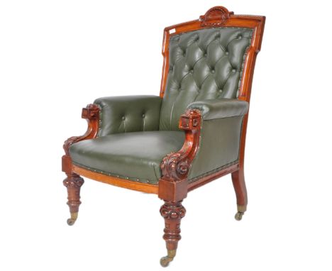 A 19th Century William IV carved mahogany library reading armchair. The arm chair with carved fan and laurel leaf top, green 