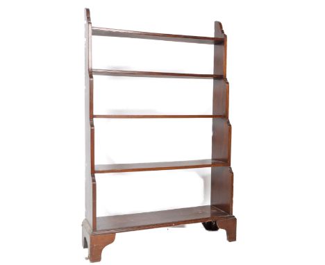 A 19th Century waterfall bookcase. The graduating set of open shelves having five fixed shelves / tiers with shaped sides all