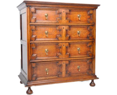 A late 19th Century Jacobean revival geometric block fronted oak chest of drawers having bun feet with bank of four drawers h