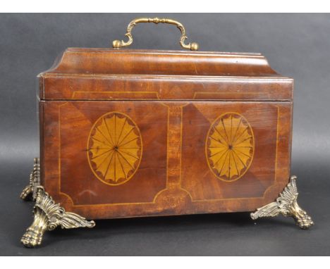 An Regency Revival mahogany casket box caddy of sarcophagus form having a raised cover with inlaid decoration and brass handl