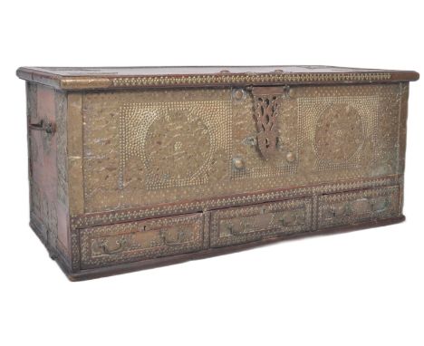 A large 19th Century teak brass studded Zanzibar trunk. The front panel intricately decorated with brass applied mounted and 