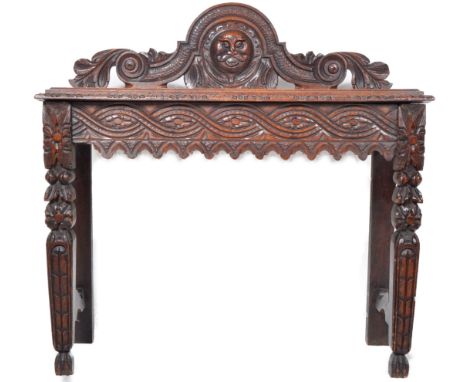 A 19th century Victorian oak carved Jacobean revival console table / hall table. Raised on square tapering carved legs with c