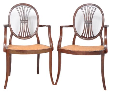 A pair of 19th Century Hepplewhite manner armchairs having round / circular shield shaped backs with central wheatsheaf splat