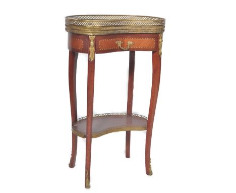 A 19th Century French mahogany and kingwood bedside table chest of kidney shaped form having a pierced brass gallery surround