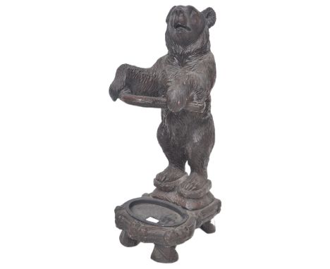 A 20th Century composite resin German Black Forest style faux carved wood umbrella stand / stick stand in the form of a bear.