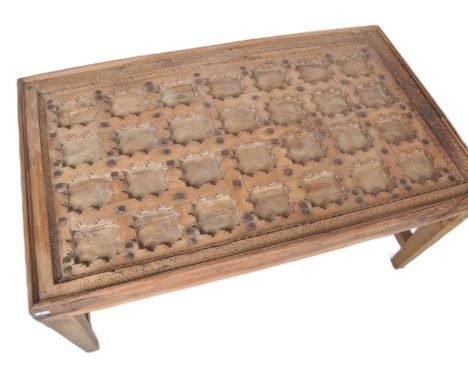 A large dining table constructed from a 19th Century Moroccan panel door. The door having multiple carved square sections wit
