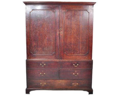 An 18th Century George III oak country house housekeepers cupboard / linen press comprising of a large twin door cupboard top