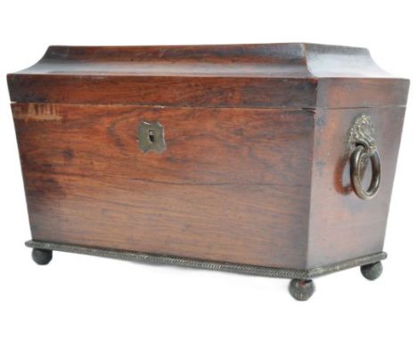 A large 19th Century Regency rosewood tea caddy of sarcophagus form. The outer case of simple form having a brass hoop swing 