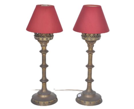 A pair of 19th Century Gothic style converted table lamp light of brass worked construction having foliate worked gallery top