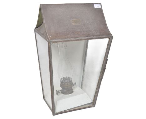 A large 19th Century Victorian oil copper porch lantern of typical street lamp light form. Shaped top with four glass panels 