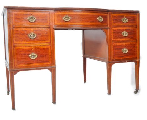 Maple &amp; Co - A 19th Century fiddleback mahogany serpentine sideboard credenza / writing table desk having a series of dra